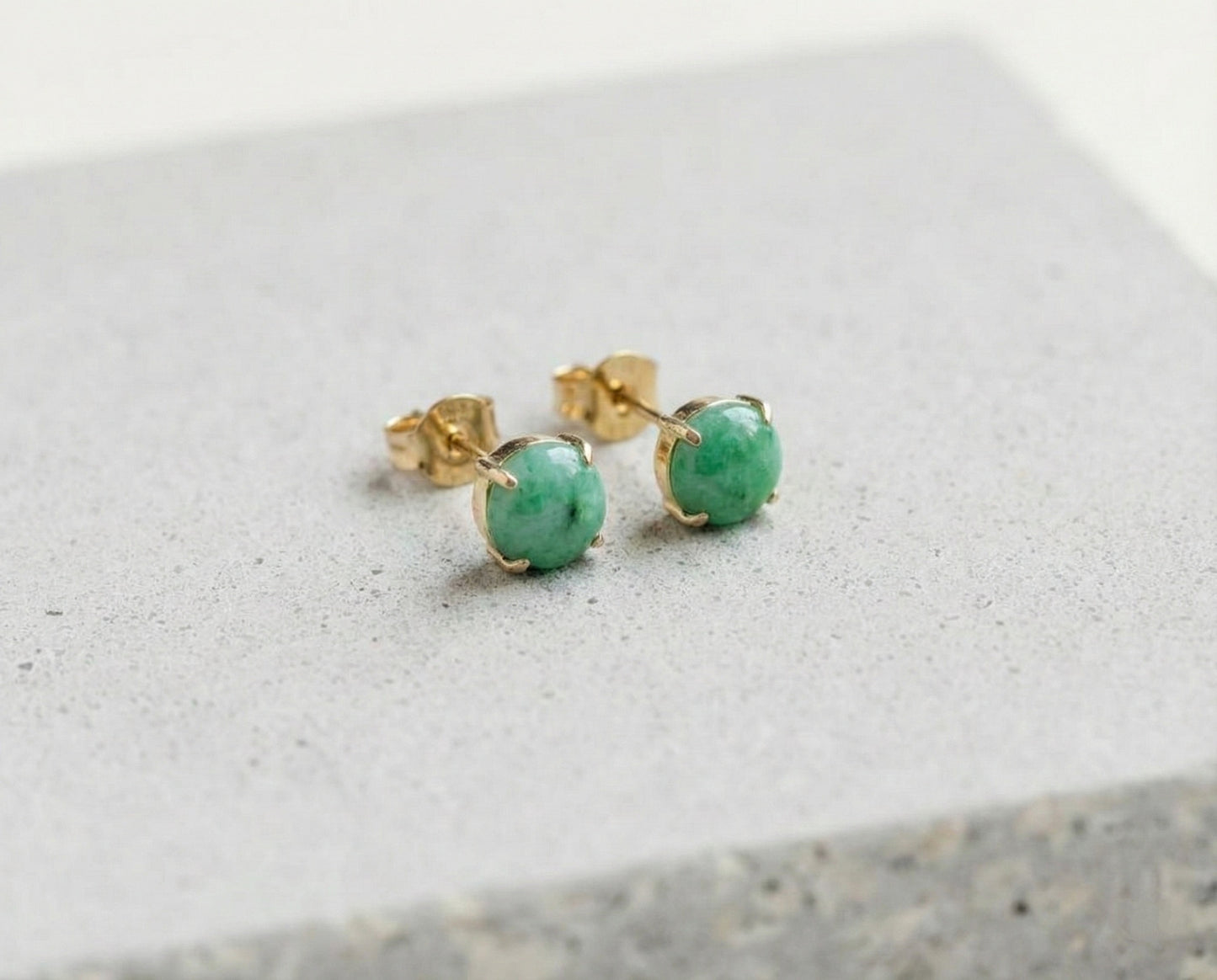 Green jade stud earrings with claw setting in 18k yellow gold